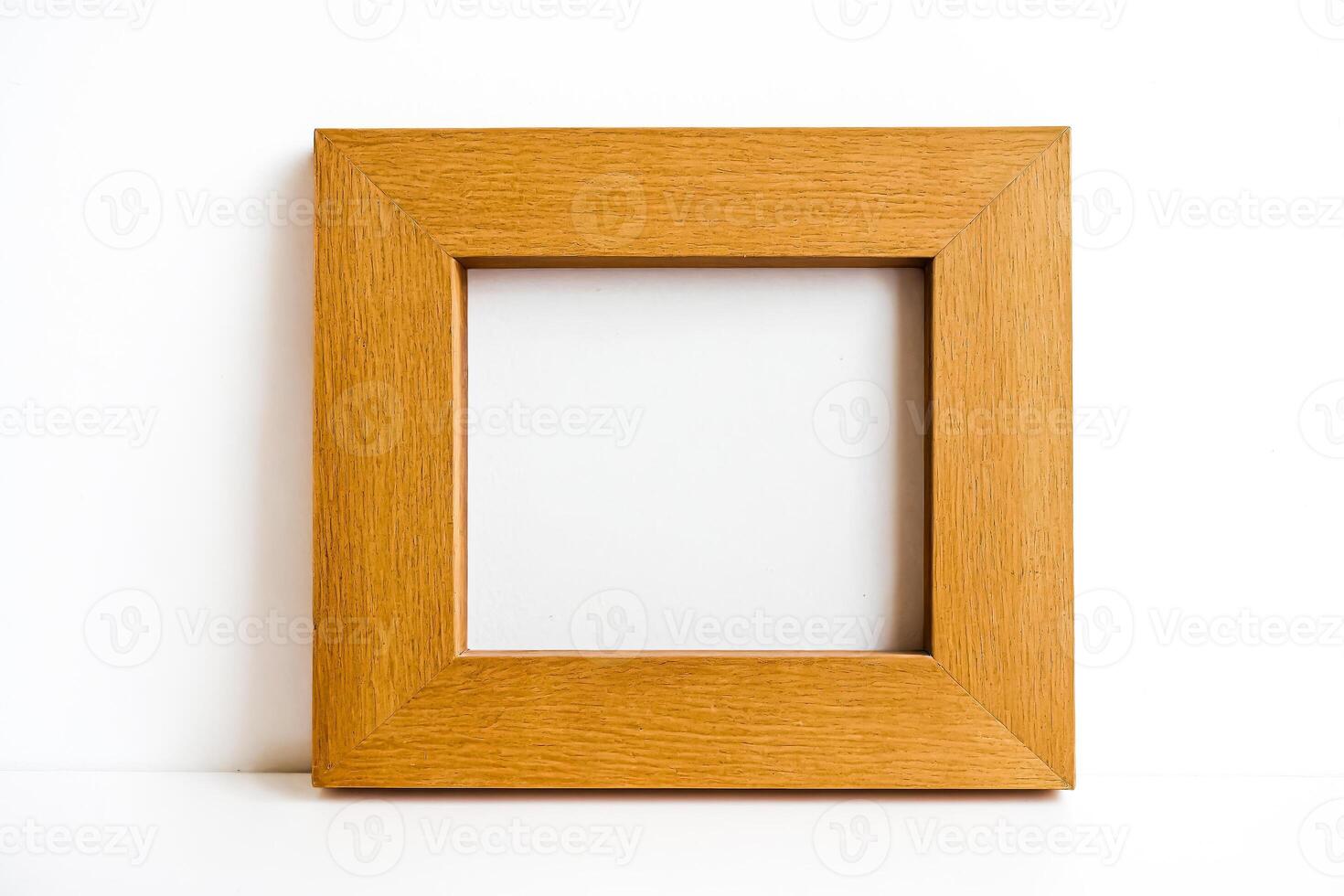 Wooden picture frame on white background photo