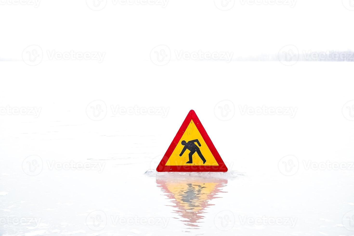 Thin Ice Warning Sign on Frozen Lake photo