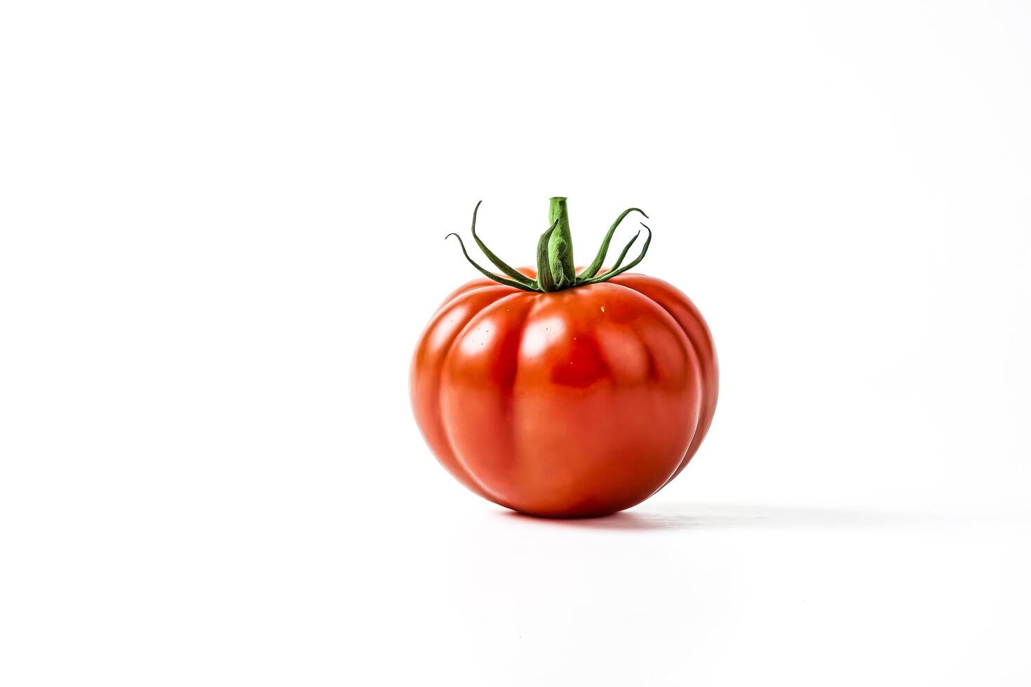 Single Red Tomato on White Background photo