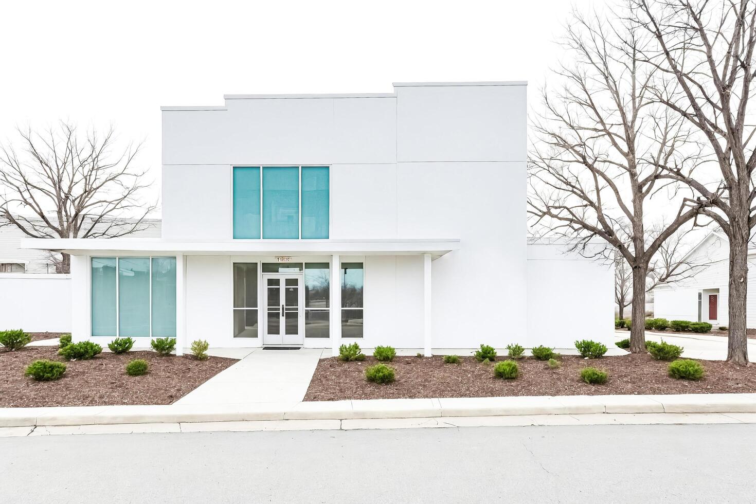 Modern White Building with Glass Windows and Doors photo