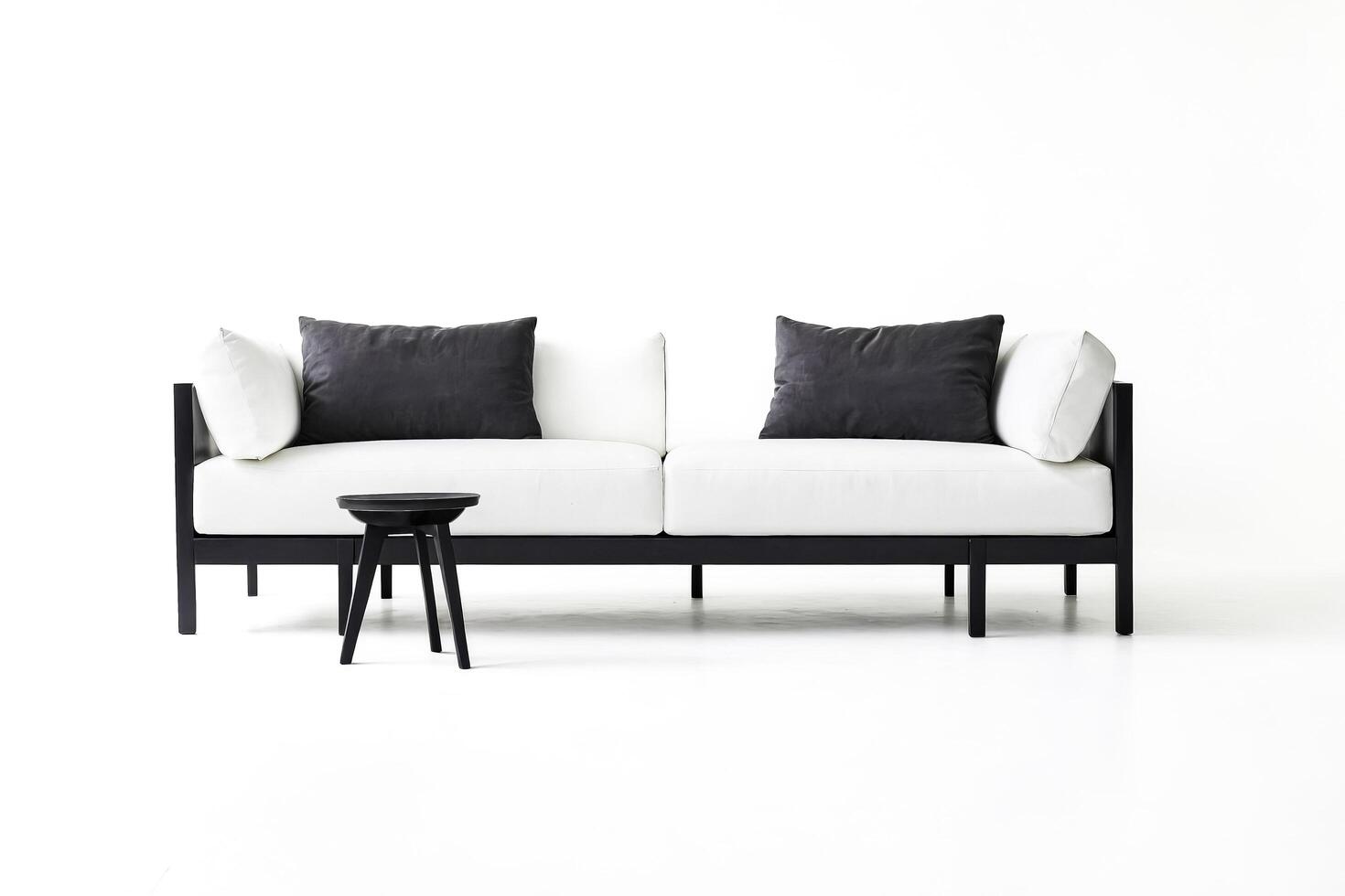 White Sofa with Black Frame and Pillows on White Background photo