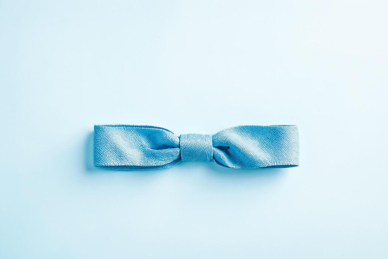 Blue bow on a blue background photo