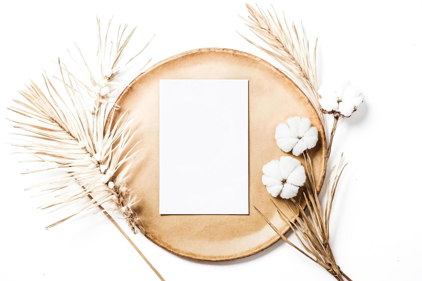 Blank Card with Dried Palm Leaves and Cotton Flowers on a Wooden Plate photo