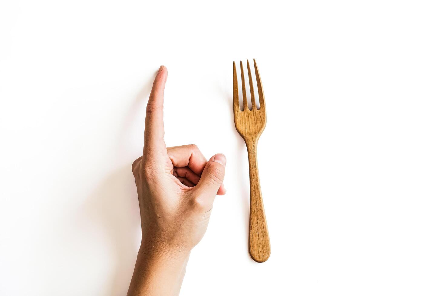 Wooden Fork and Hand Pointing photo