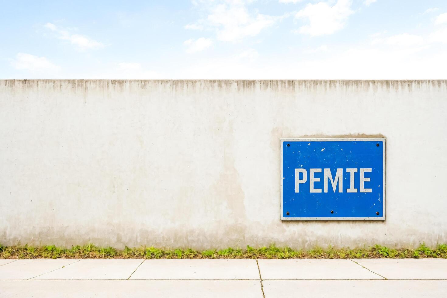 Blue Sign on Concrete Wall photo