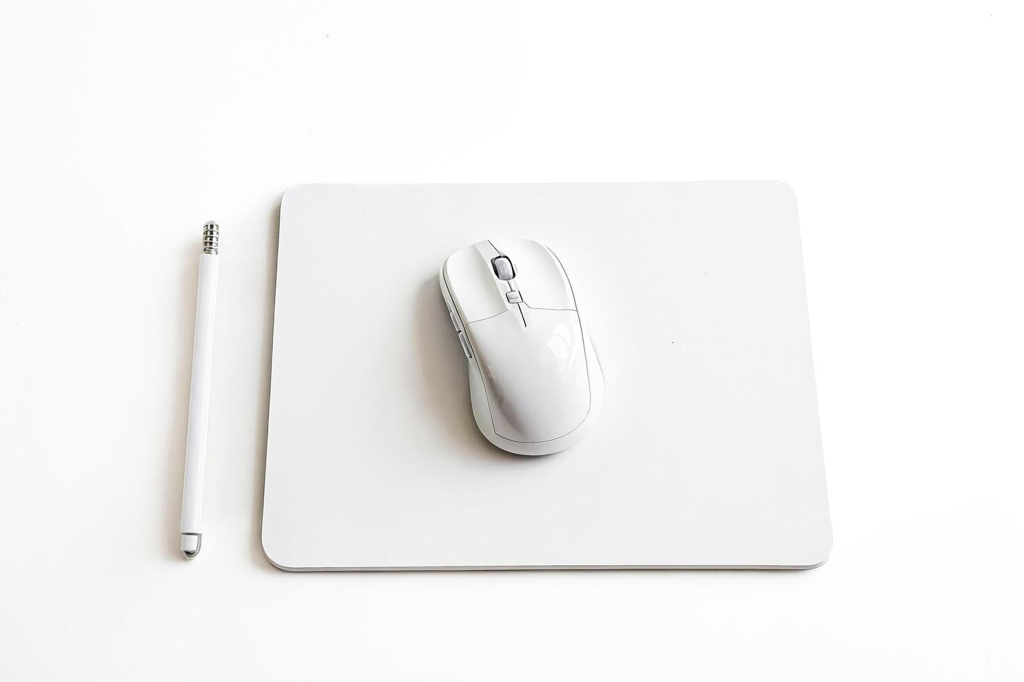 White Mouse and Pen on White Surface photo
