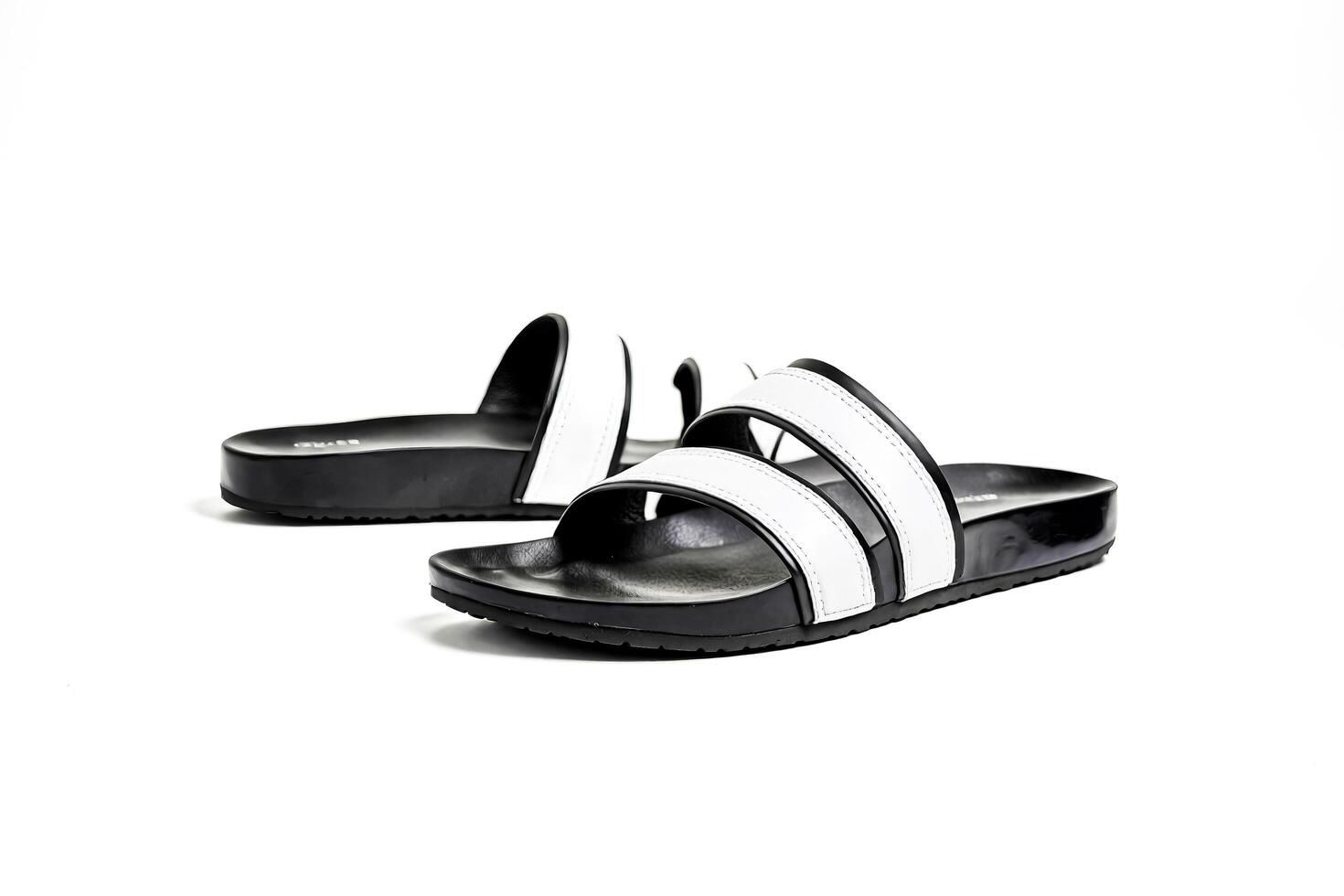 Black and White Leather Sandals on White Background photo