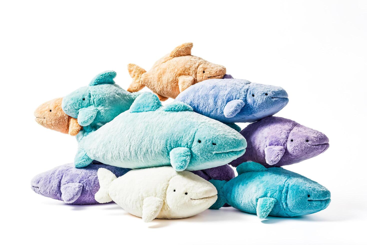 Plush Fish Toys Stacked On White Background photo