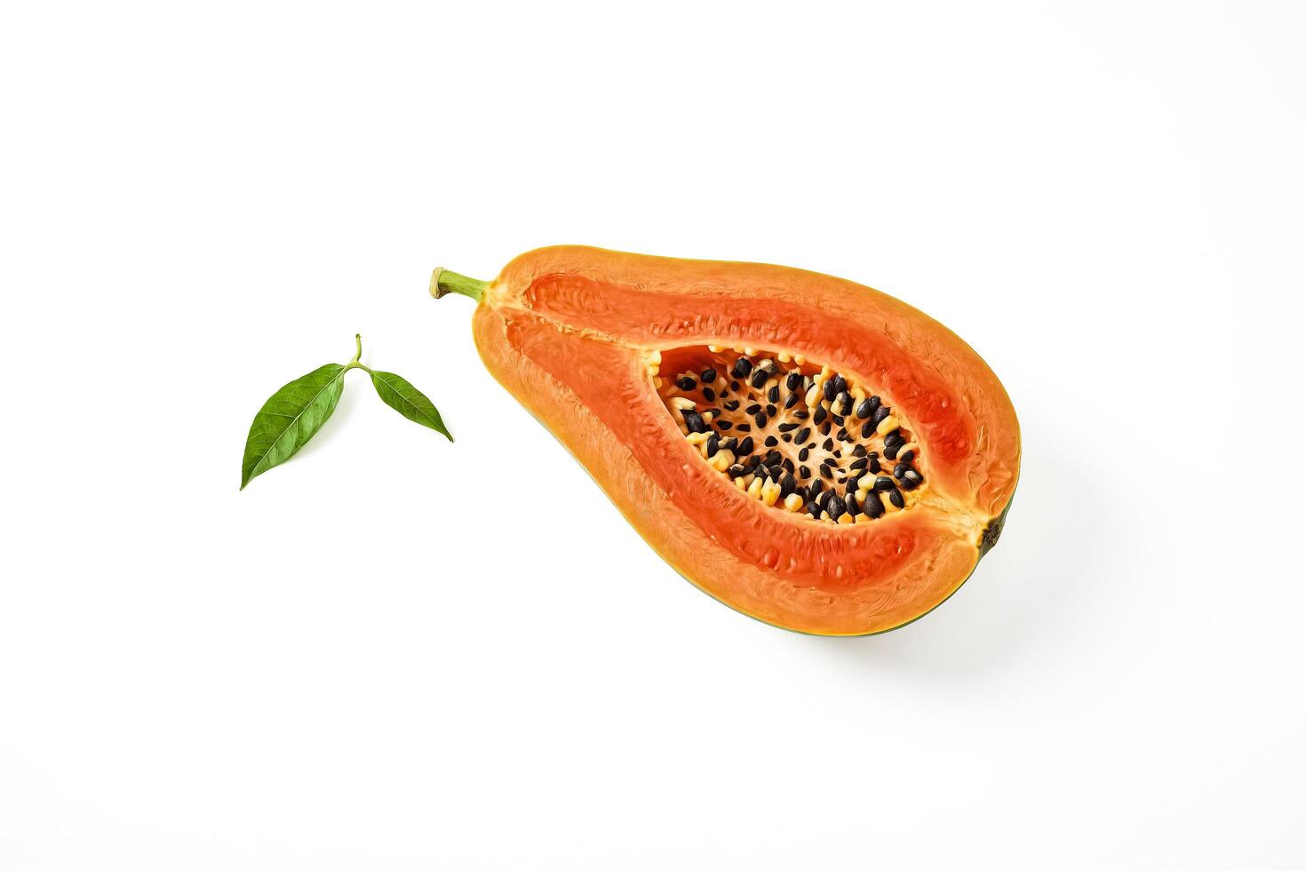 Half of a papaya with black seeds on a white background photo