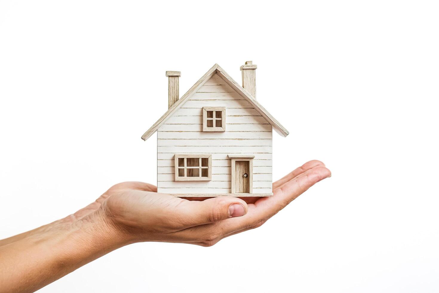 Hand Holding Miniature Wooden House Model photo