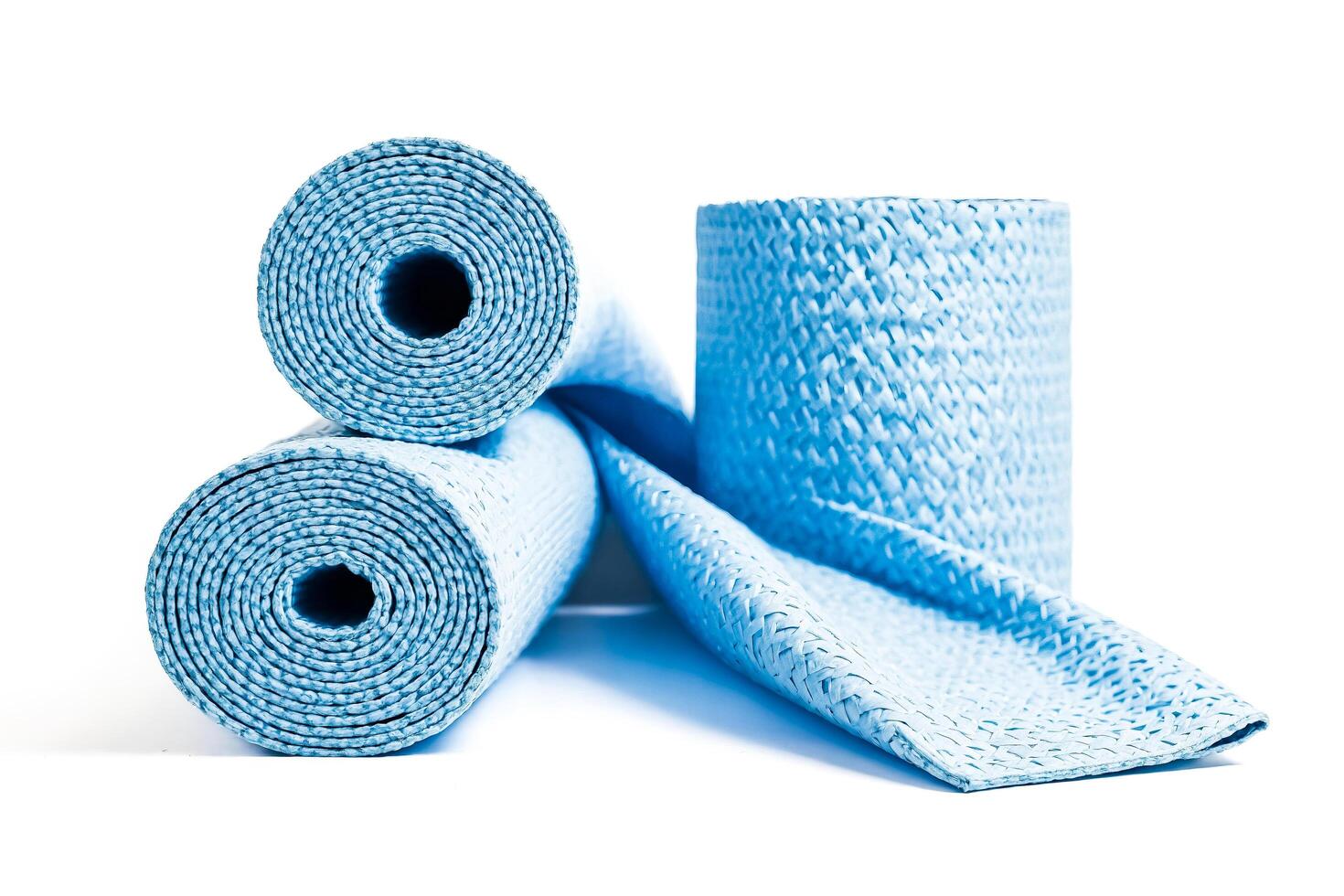 Blue Rolled Up Yoga Mat Isolated On White Background photo