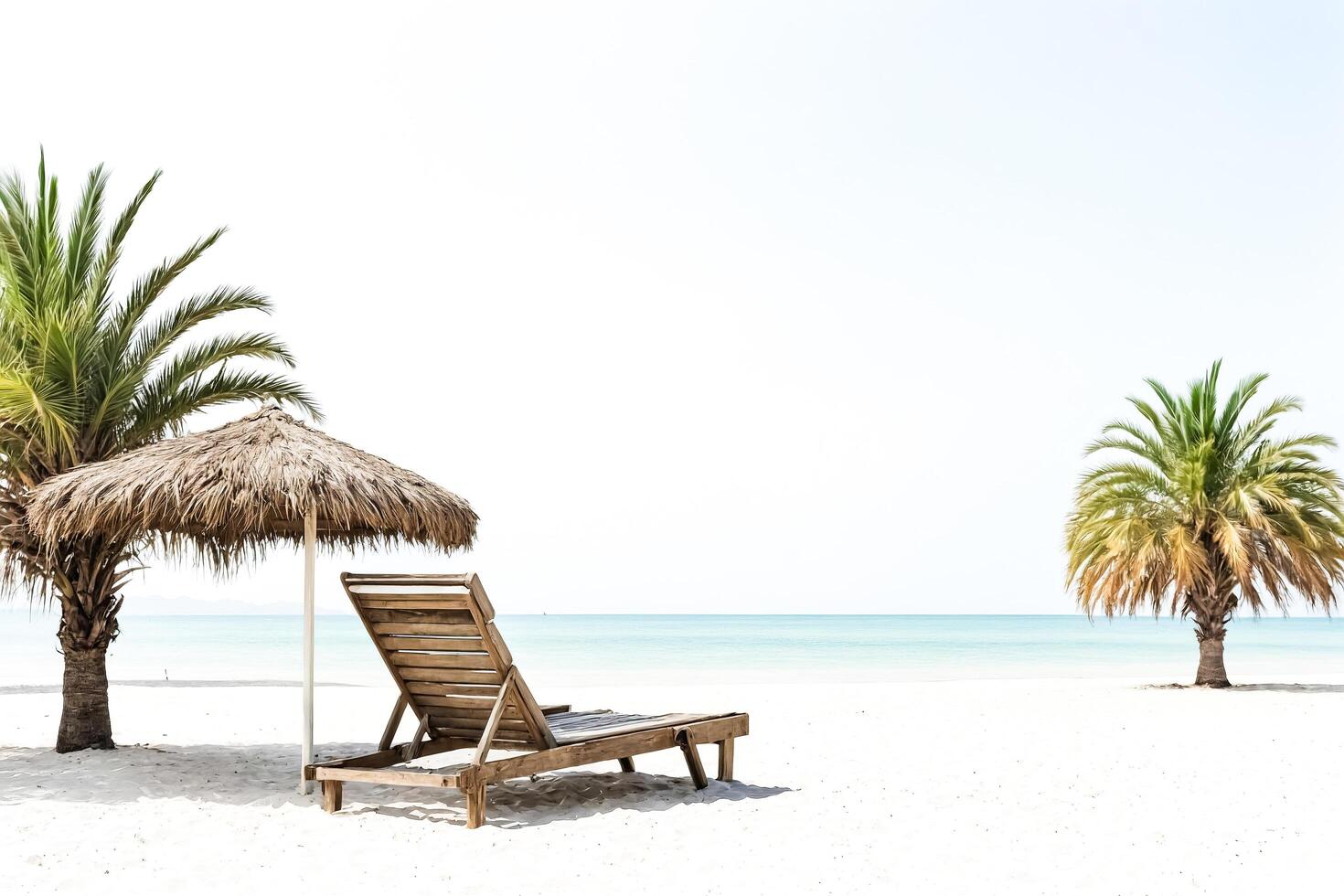 Beach chair under a palm tree umbrella photo