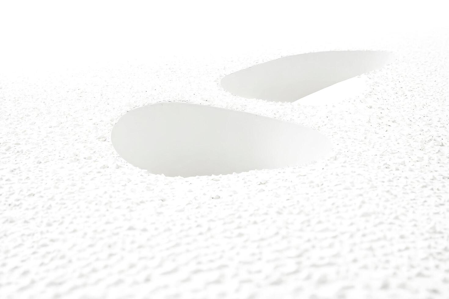 Abstract White Textured Surface with Two Circular Cutouts photo