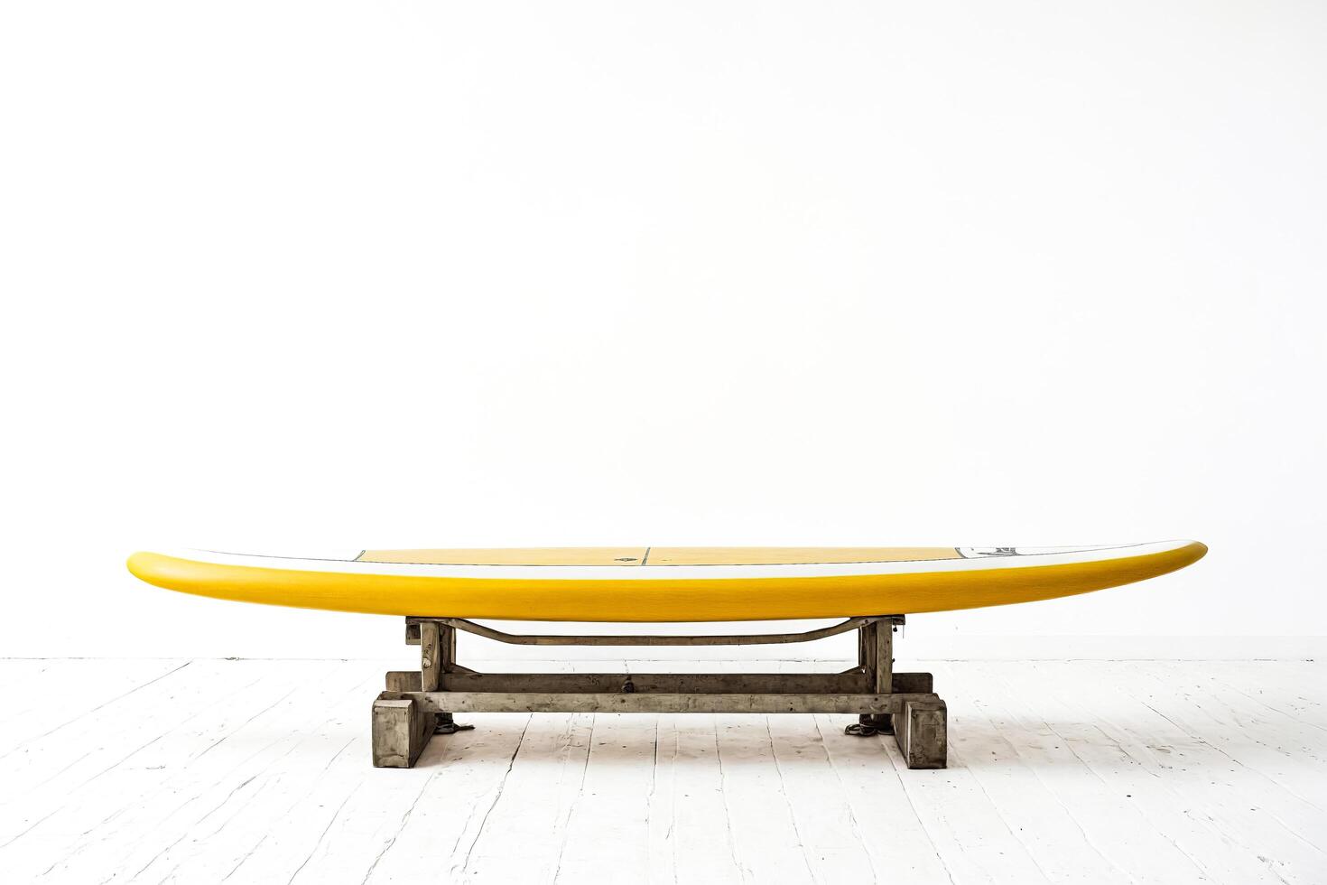 Yellow Surfboard on Wooden Stand photo