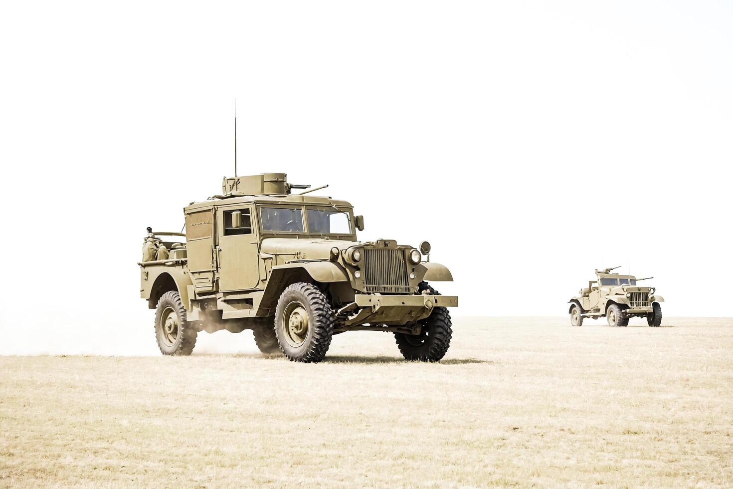 Vintage Military Jeep Driving on Grass Field photo