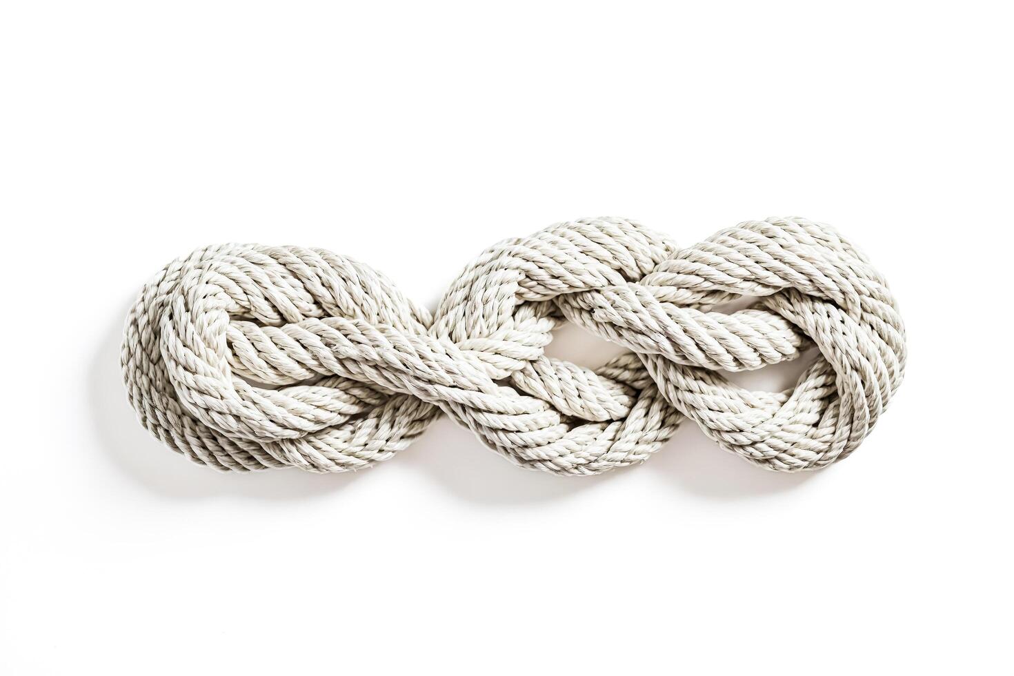 Closeup of a white rope knot on a white background photo