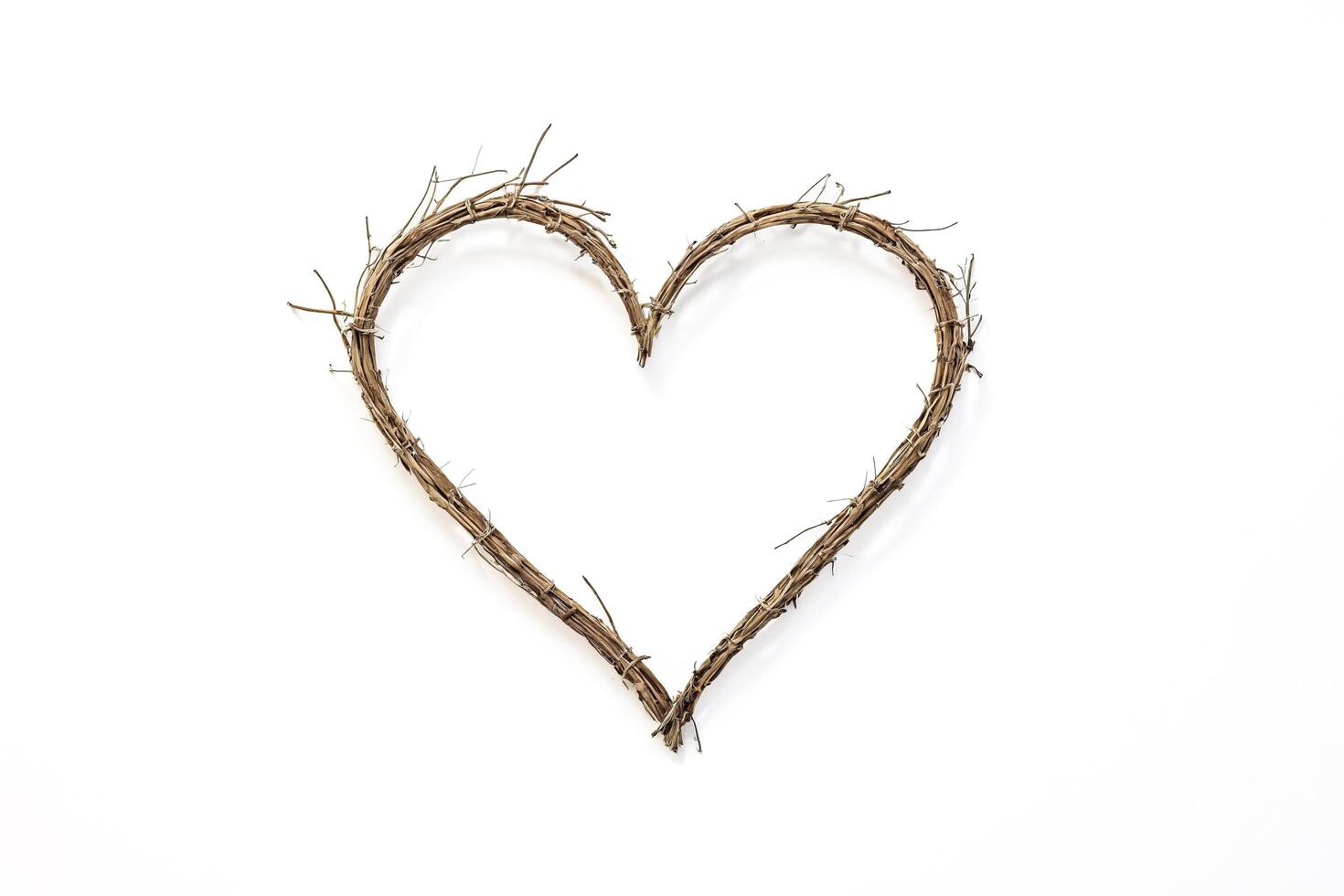 Heart Shape of Twisted Twigs on White Background photo
