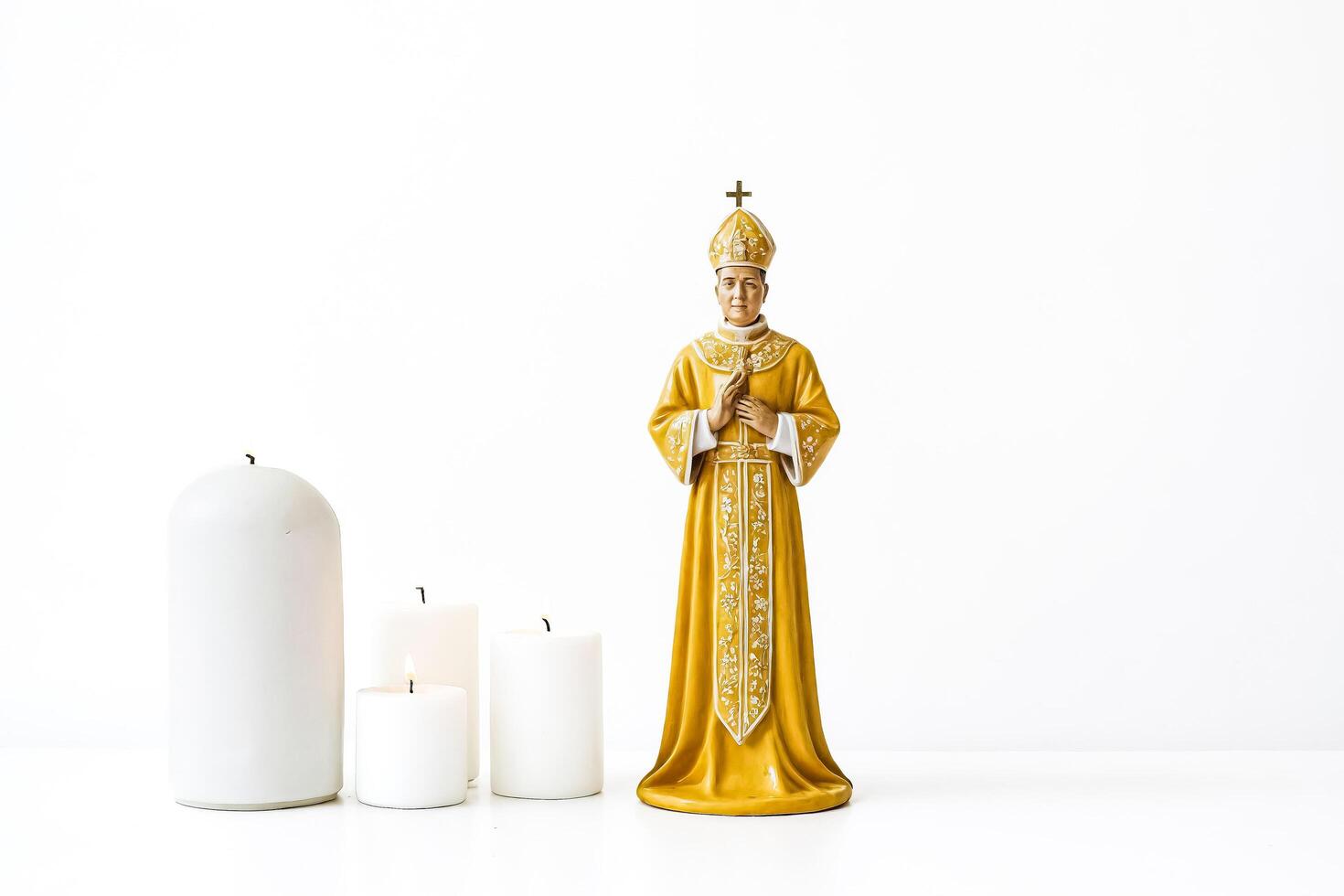 Religious Statue with Candles on a White Background photo