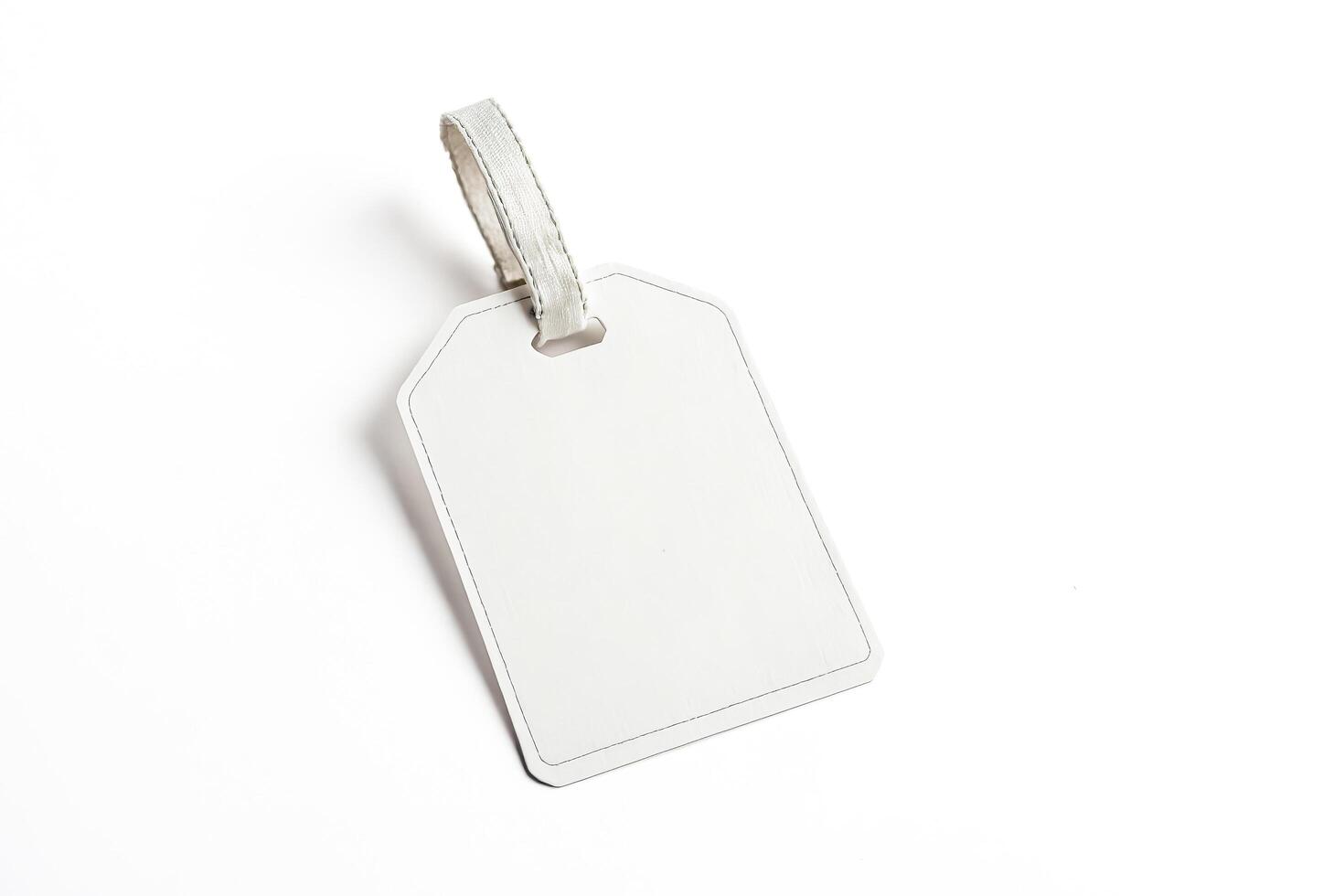 Blank white tag with string loop isolated on white background photo