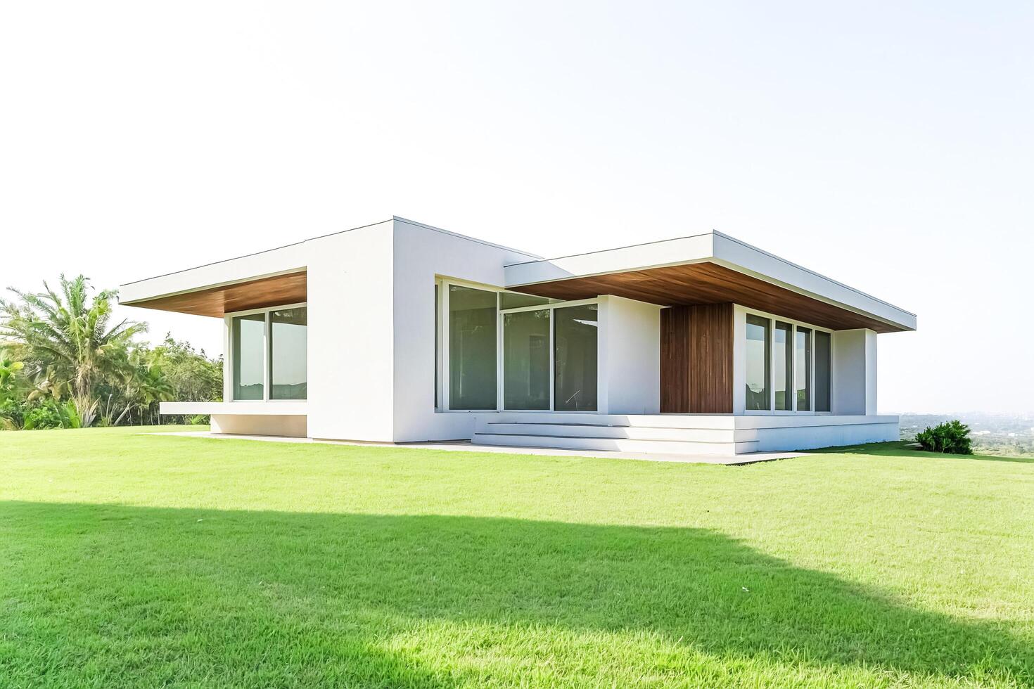 Modern House with Large Windows and Wooden Accents on a Grassy Lawn photo