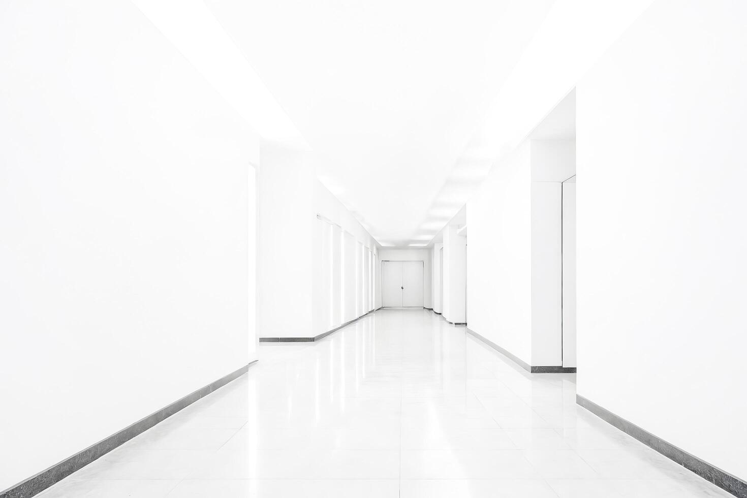 Minimalist White Corridor with Door at the End photo