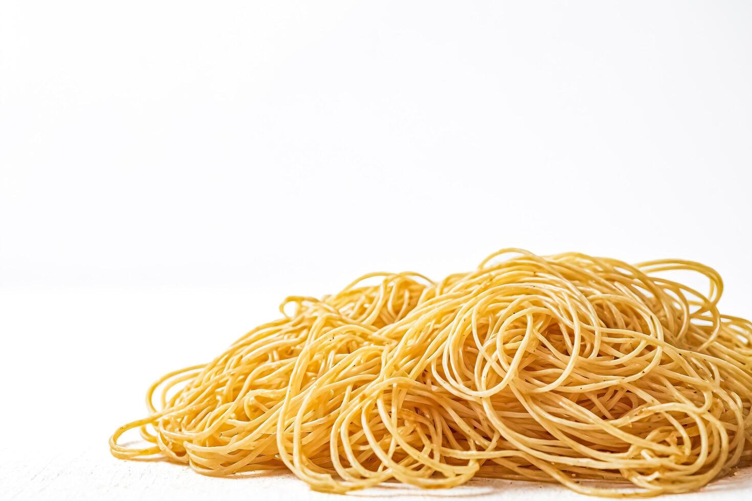 Closeup of Spaghetti Noodles on White Background photo