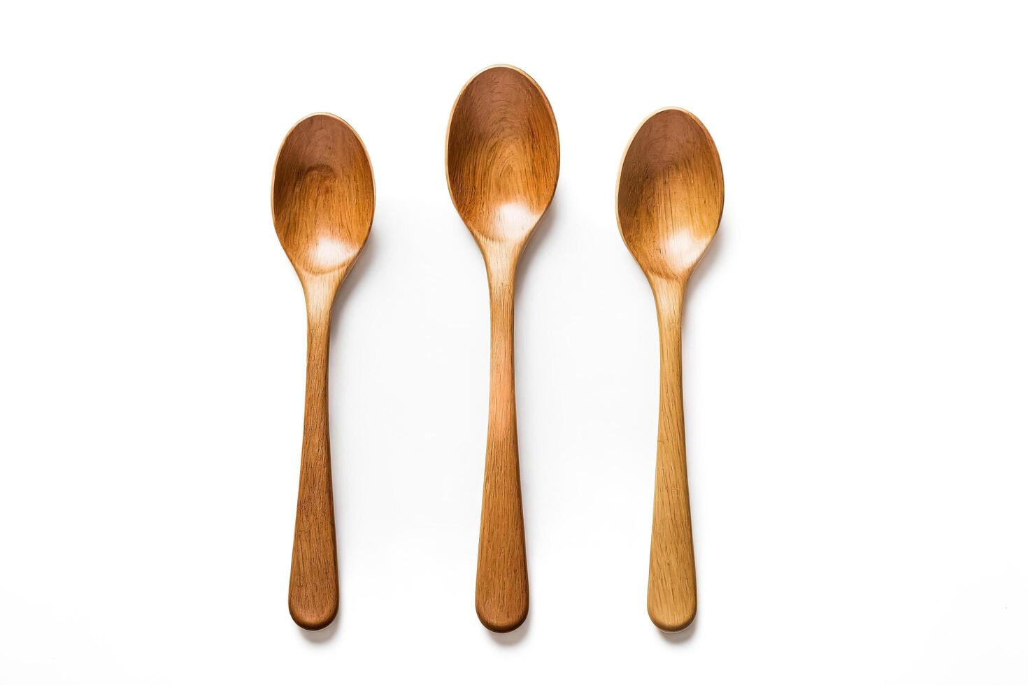 Three wooden spoons on white background photo