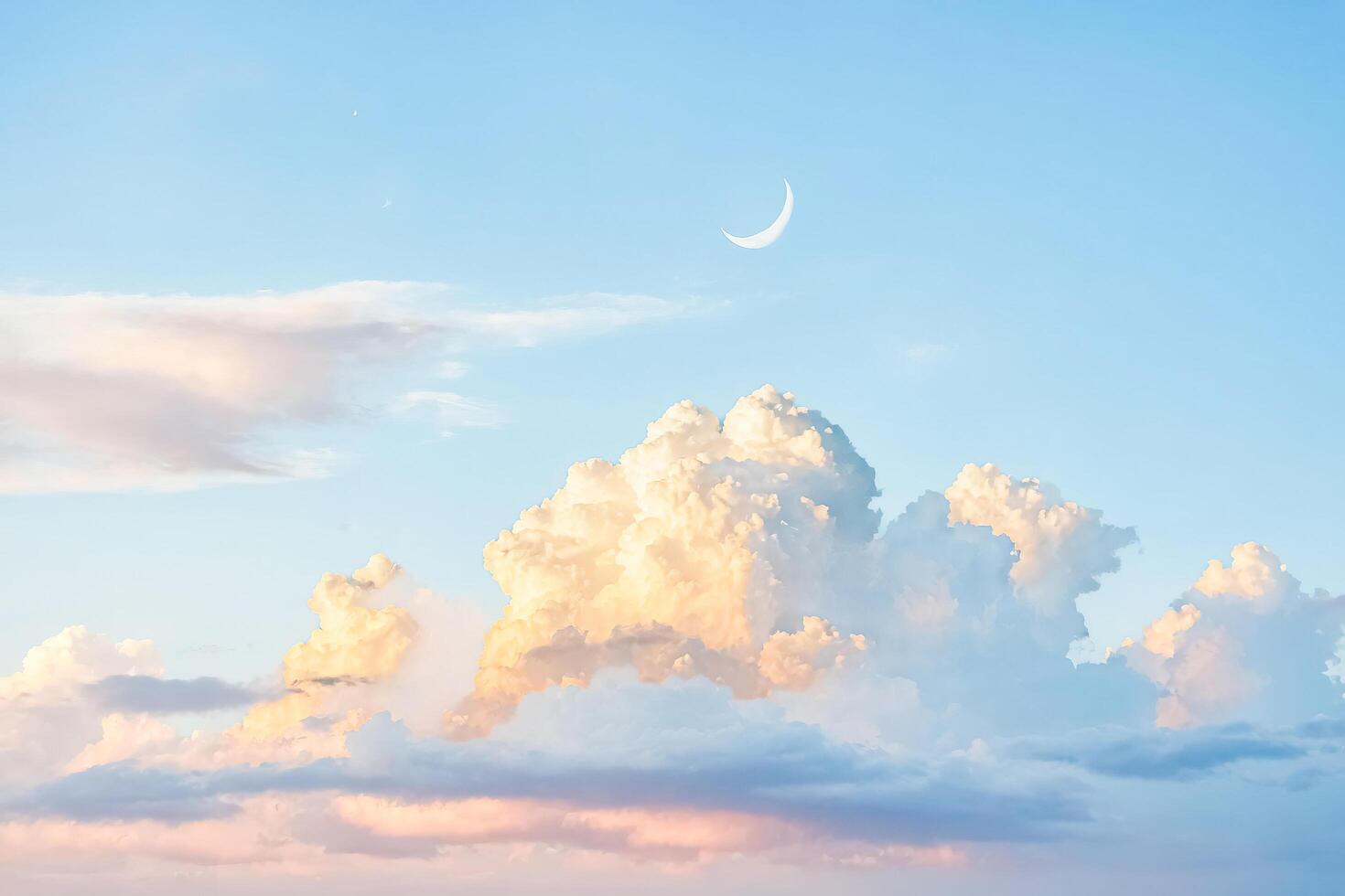 Crescent Moon and Fluffy Clouds in a Blue Sky photo