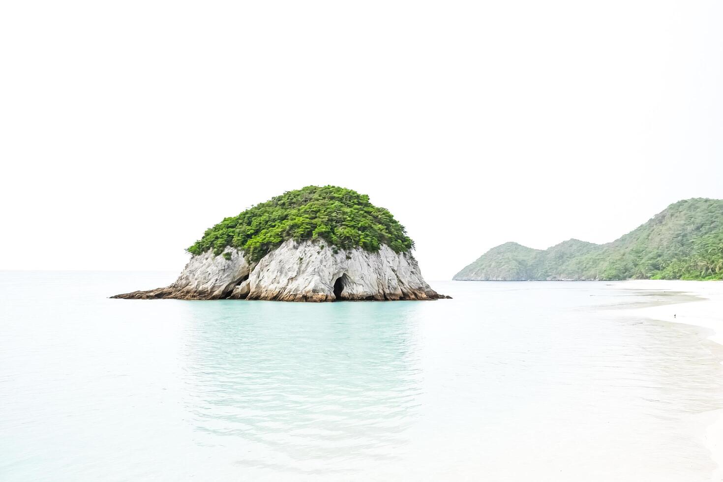 Tranquil Island with a Cave in the Rocks photo