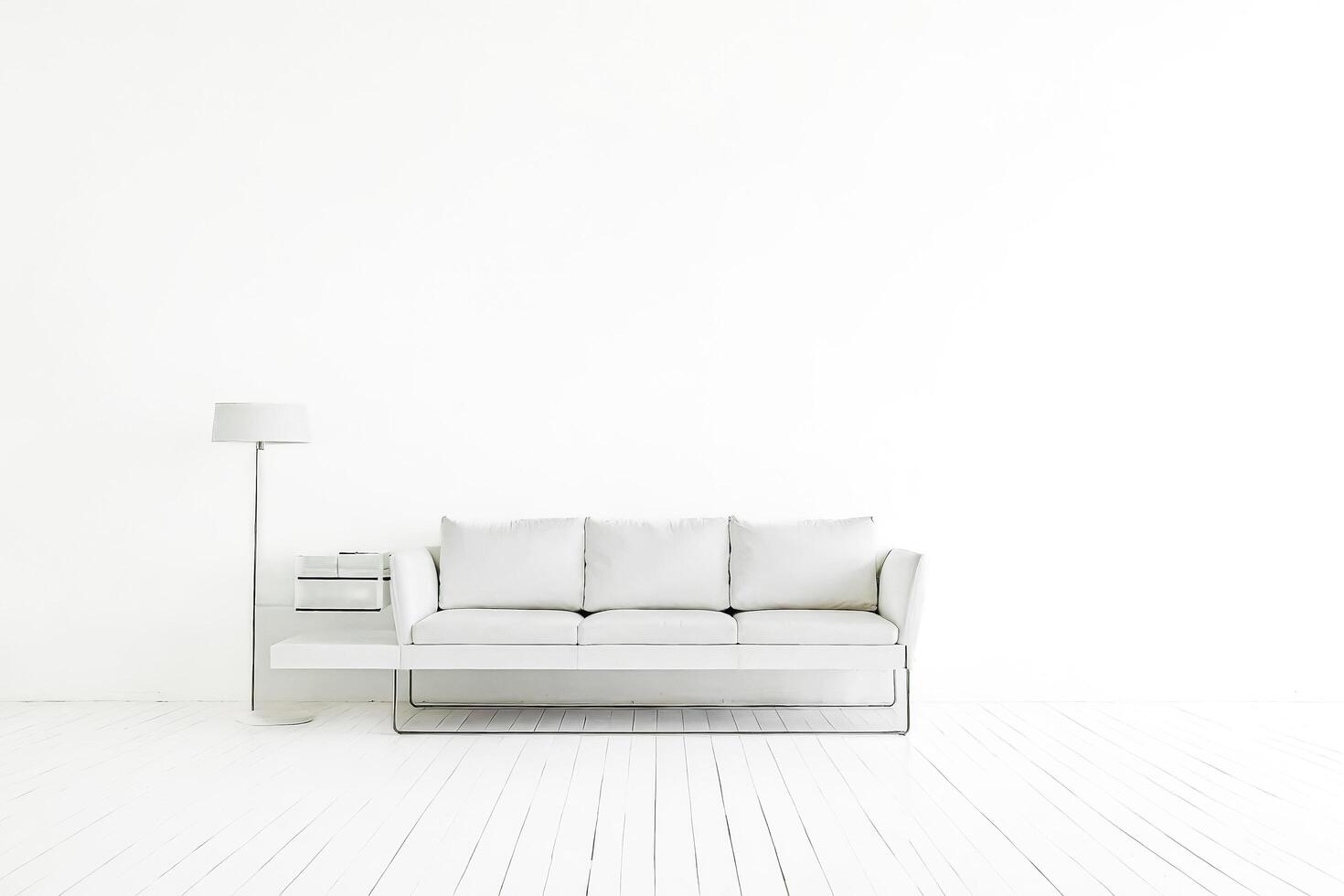Minimalist White Living Room with Sofa and Lamp photo