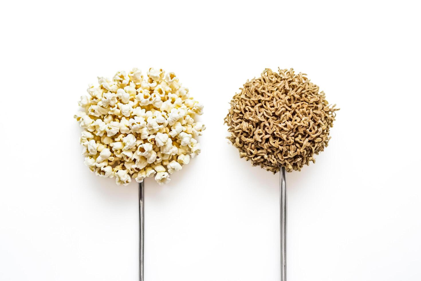 Popcorn and instant noodles on white background photo