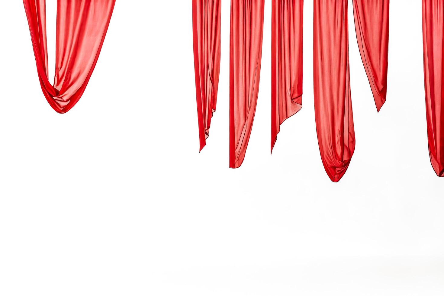 Red curtains hanging against a white background photo