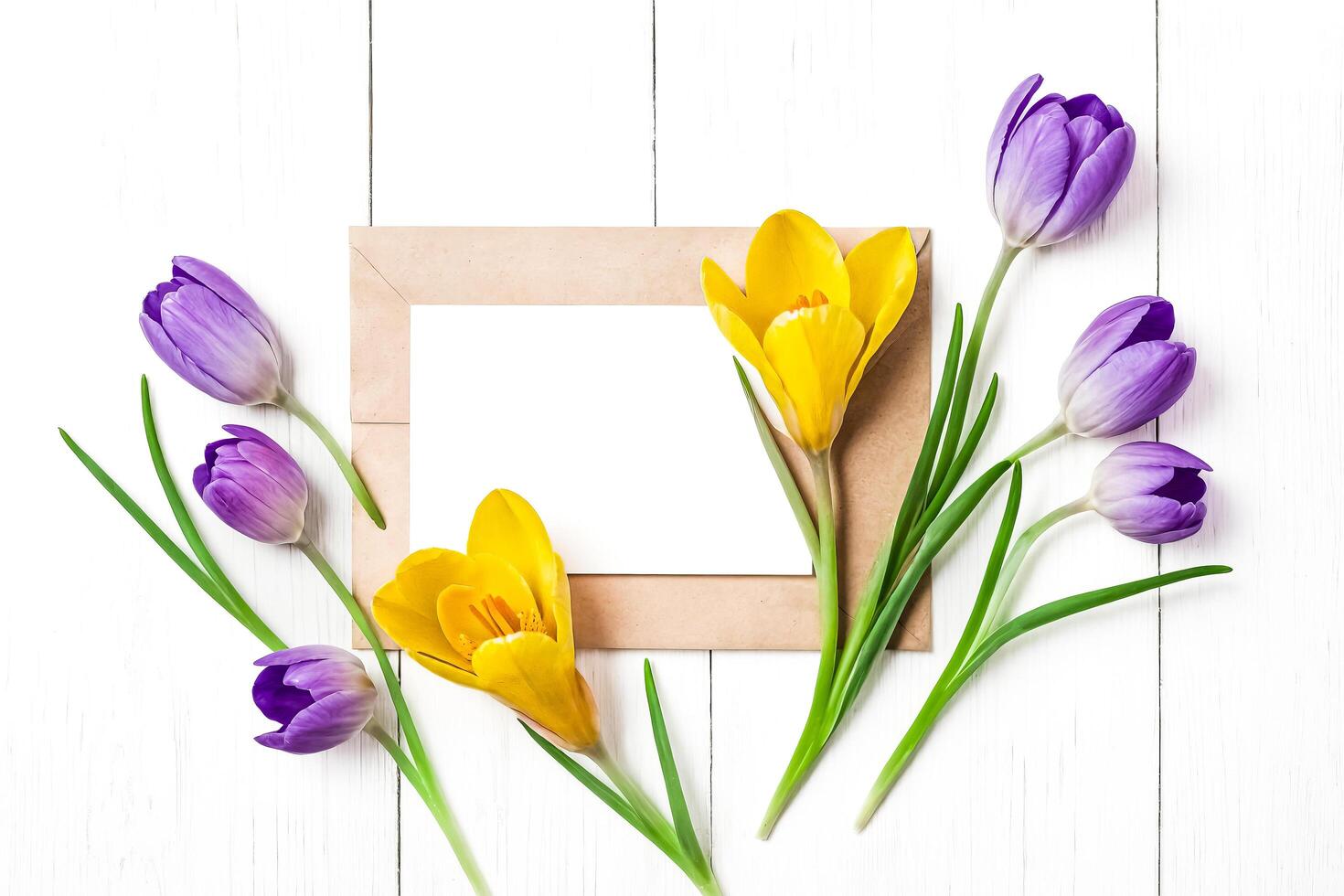 Blank Paper Card with Spring Flowers on White Wooden Background photo