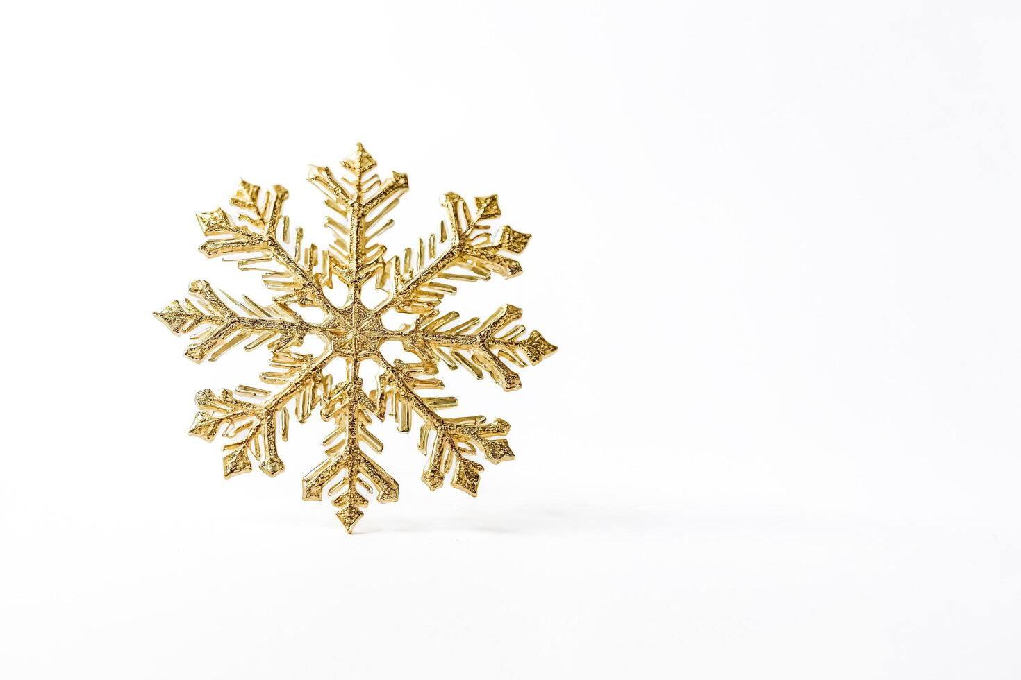 Gold Snowflake on White Background photo