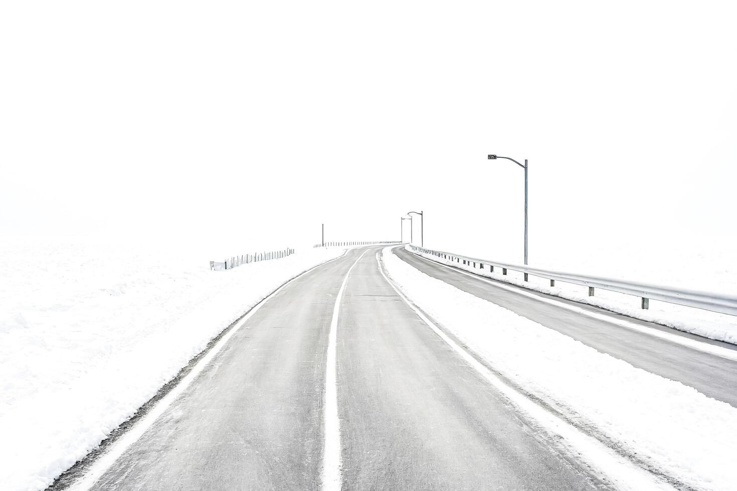 Empty Snowy Road in Winter photo