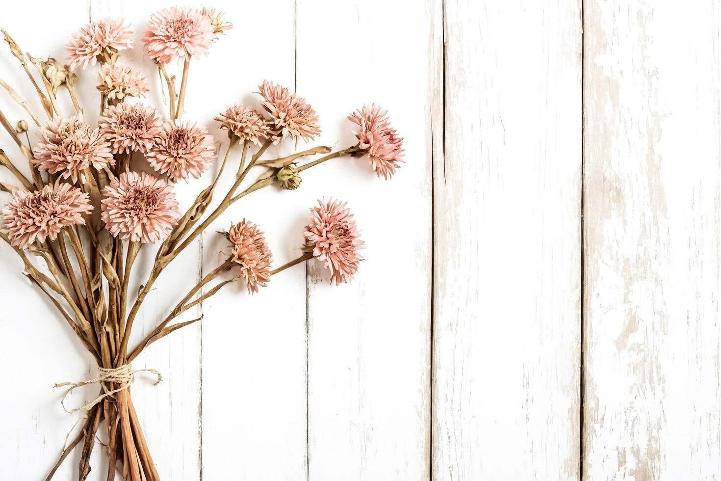 Dried Flowers on White Wooden Background photo