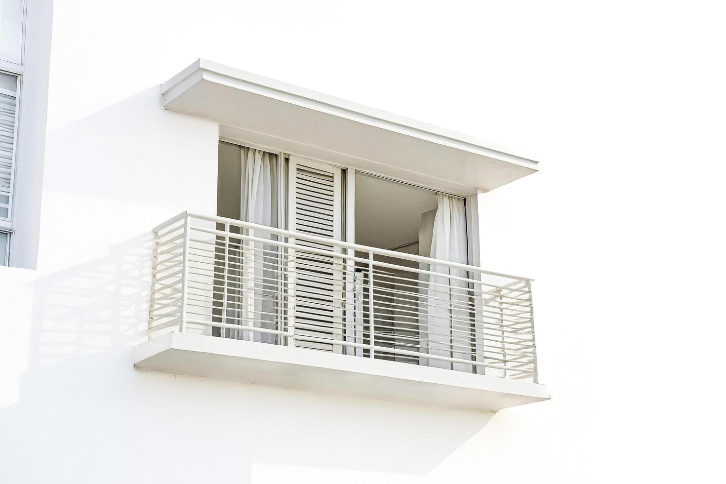 Modern Balcony with White Walls and Metal Railing photo