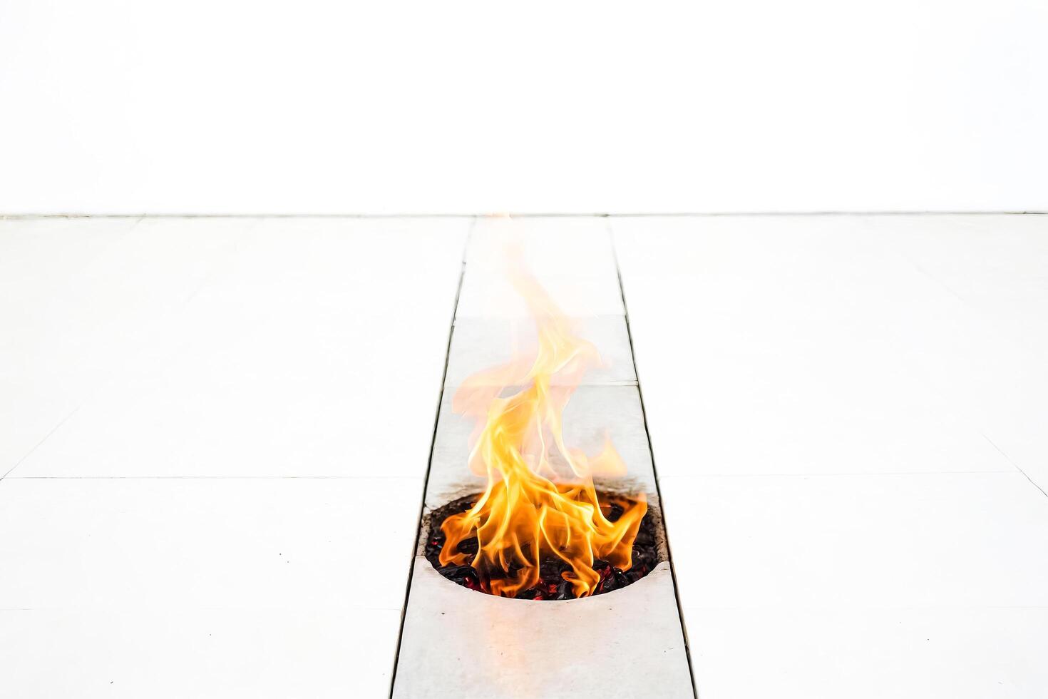 Flames of fire in a white tiled floor photo