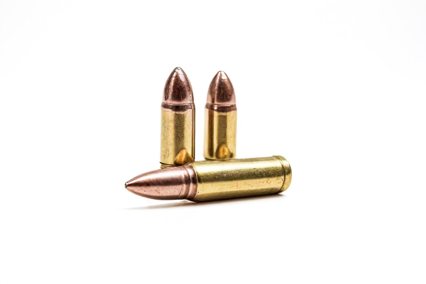 Three Bullet Shells Isolated on White Background photo