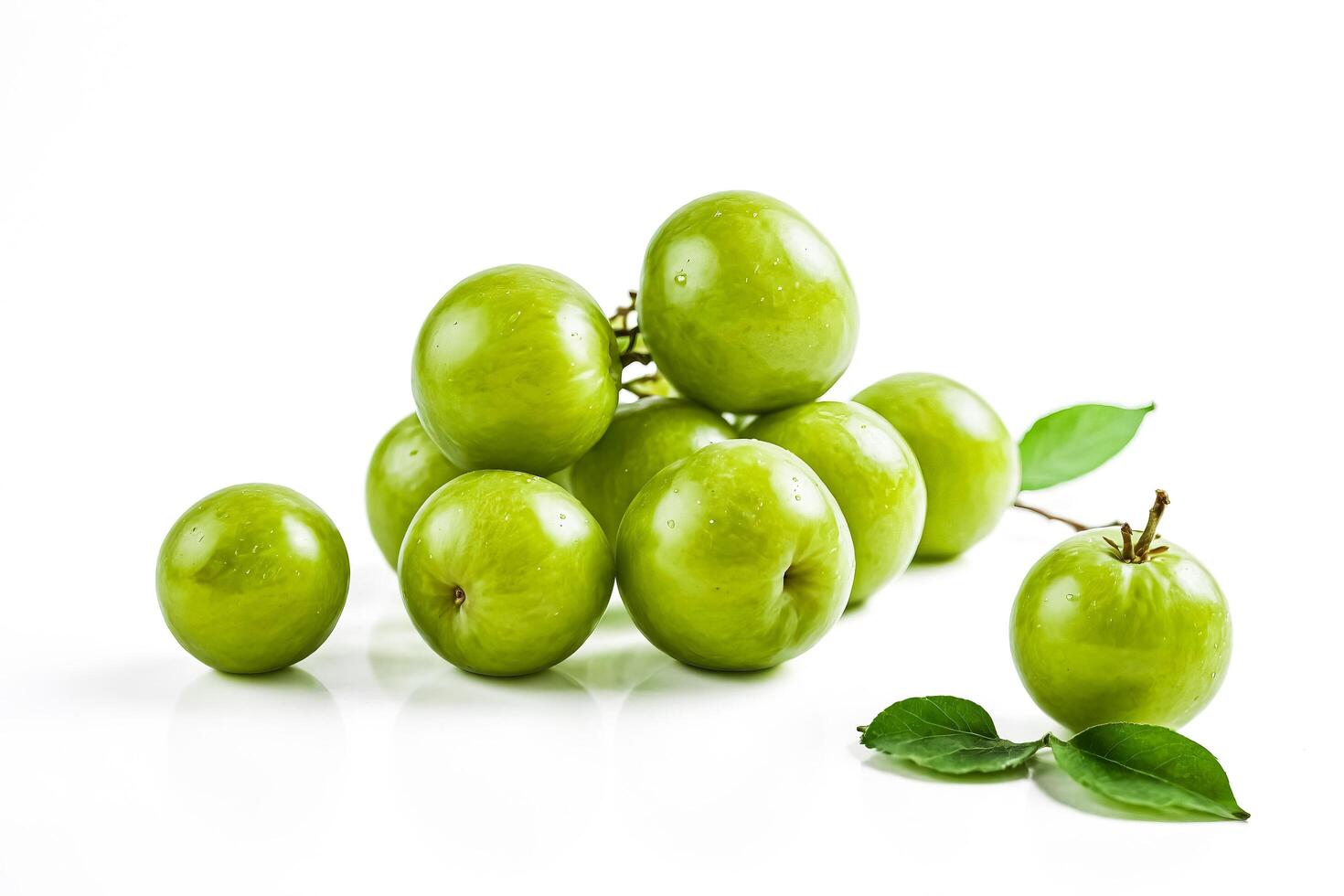 Green plums with leaves isolated on white background photo