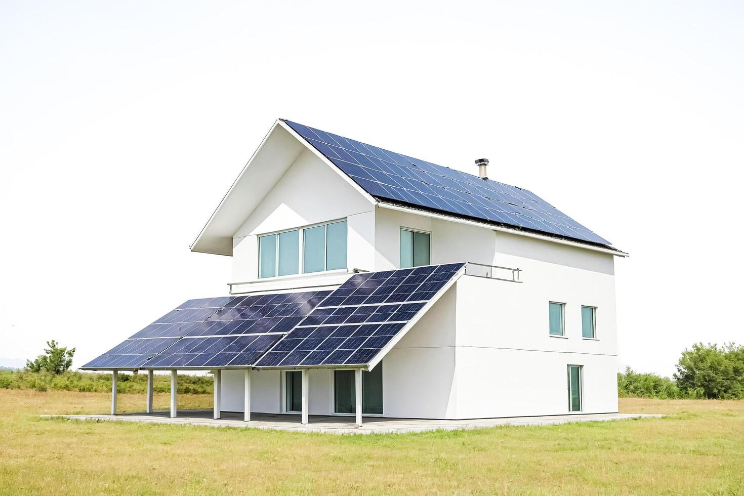 Modern White House With Solar Panels On Roof and Side photo