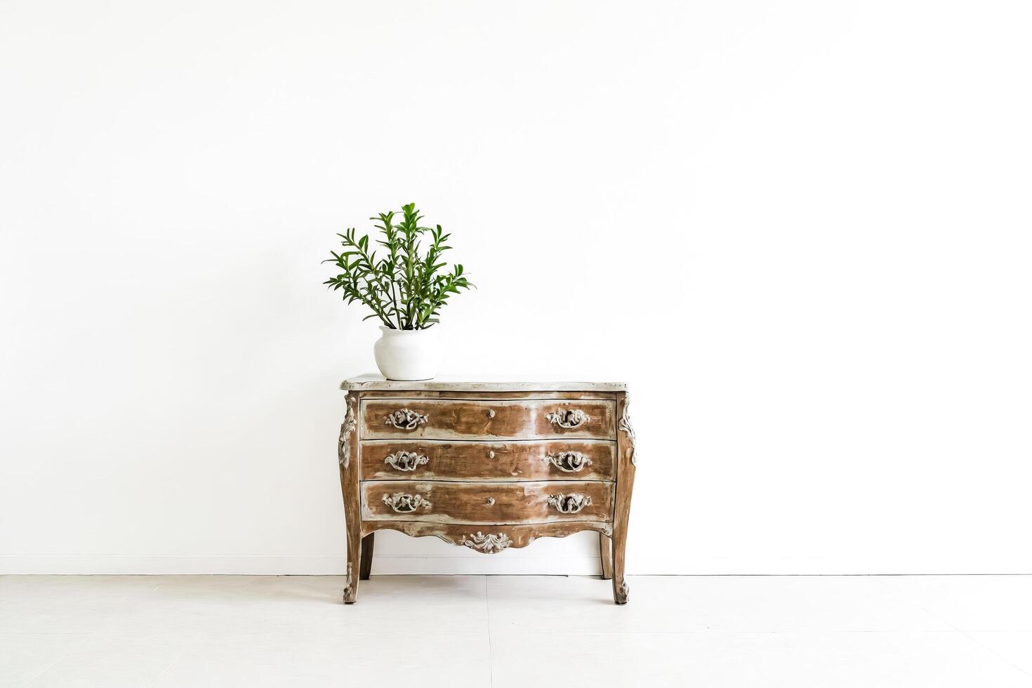 Antique Chest of Drawers Against White Wall photo