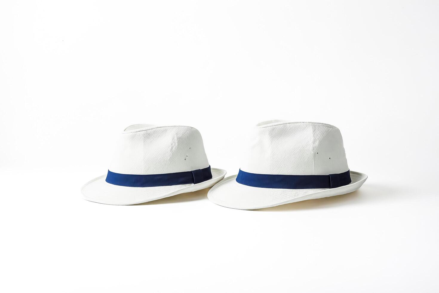 Two White Hats with Blue Bands on a White Background photo