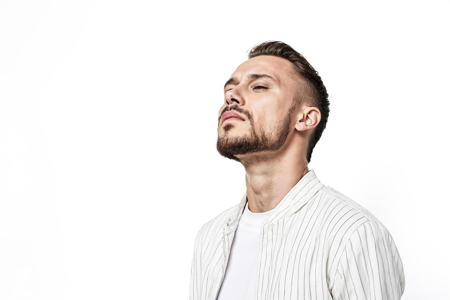 Portrait of a young man with a beard and a white shirt photo