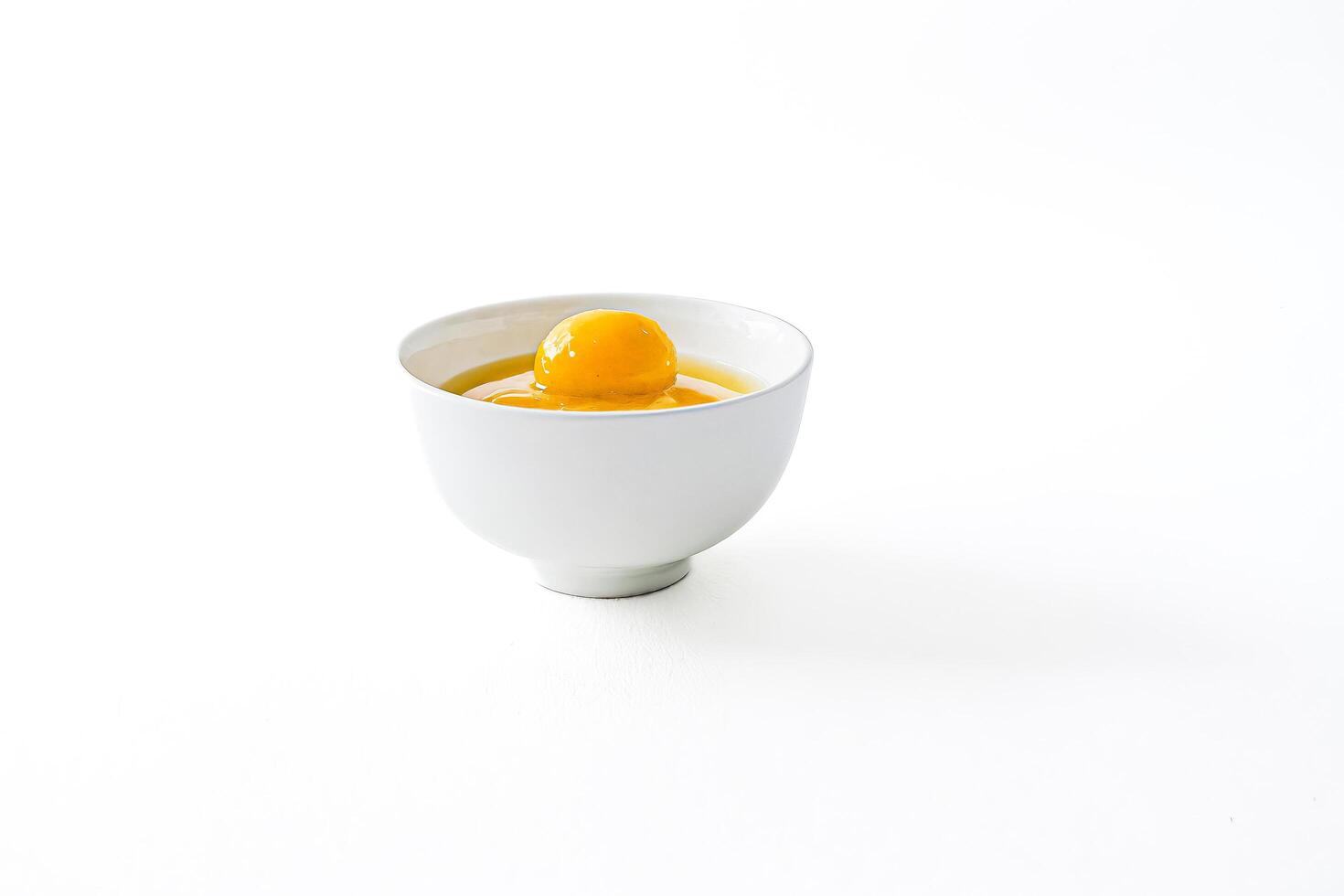 Single Egg Yolk in a White Bowl photo