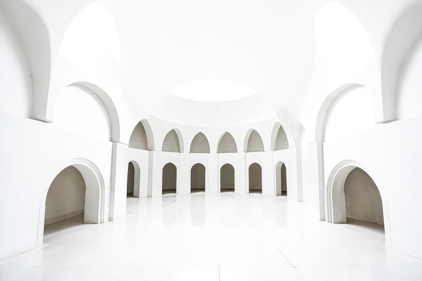 White minimalist architecture with arched doorways photo