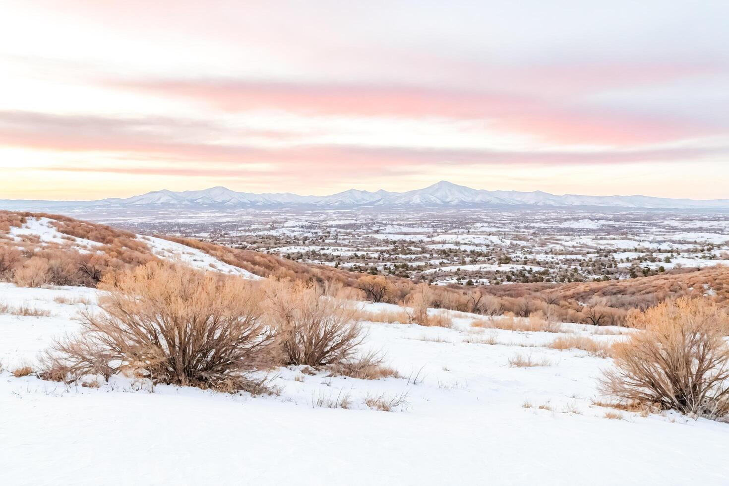 Snow-covered mountain range at sunset photo