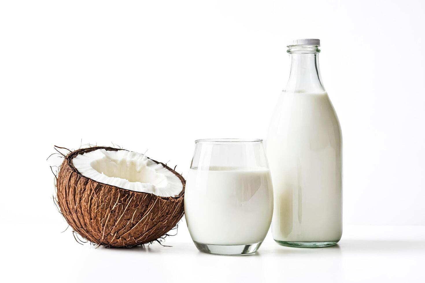 Coconut Milk in a Glass and Bottle on White Background photo