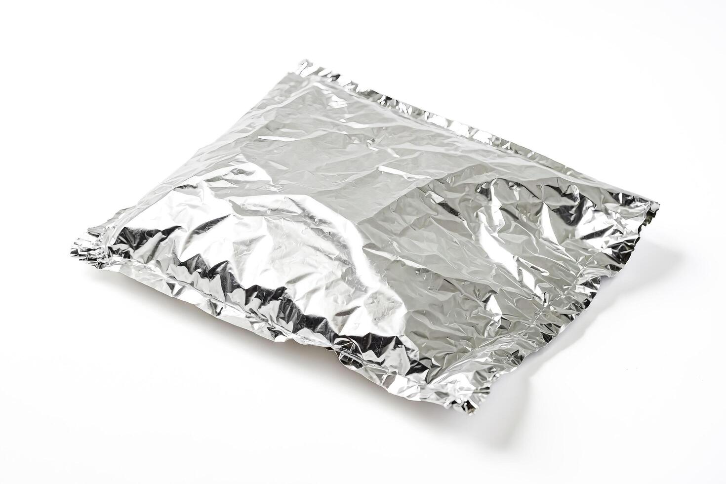 Crumpled Aluminum Foil On White Background photo