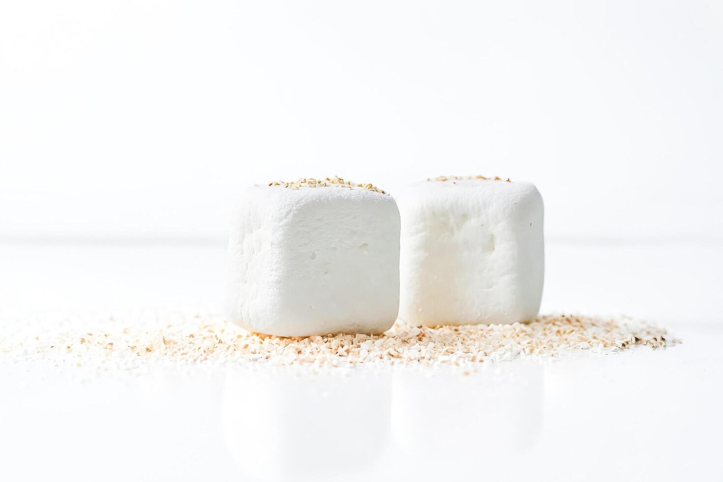 Two White Cubes with Toppings on White Background photo